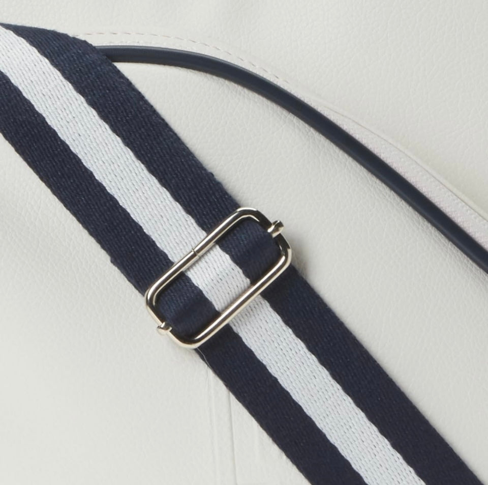 Introducing the SamLouise England 68 Pickleball Bag: a chic red bag crafted from eco-friendly vegan leather. It features zippered pockets and a shoulder strap adorned with white accents, all showcased against a pristine white background.